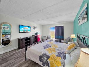 a bedroom with a bed and a living room at CRYSTAL PALACE RESORT in Bolivar Peninsula