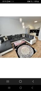 a television screen showing a living room with a couch at Apartment brand new in Seredʼ