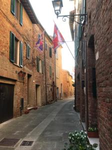 an alley with flags on the side of a building at Il Loft di Pieve in Città della Pieve