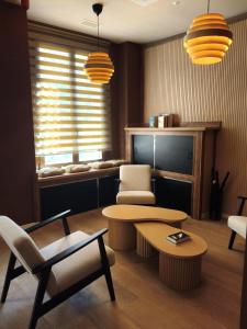 a living room with a table and a chair at Marina Boutique in Valencia