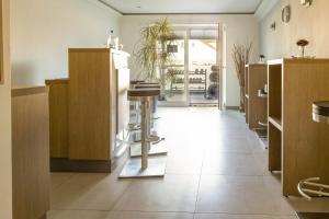 a kitchen with wooden cabinets and a table in it at Strandhotel Dranske in Dranske +69 photos