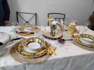 a table topped with plates and dishes on a table at Casinha de Chanca in Chanca