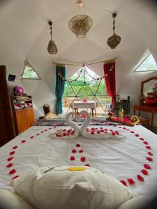 a bed with a heart made out of roses at The Tortoise Dome Lodge in Bellavista