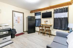 a kitchen and living room with a couch and a table at Spacious 2BR Apt • Free Parking • Baden in Baden