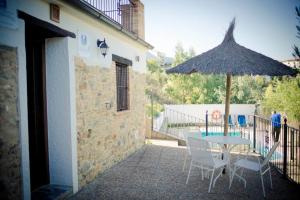 a patio with a table and an umbrella at La Estancia in El Bosque