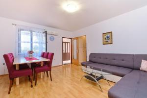 a living room with a couch and a table at Apartments Nusret in Čunski