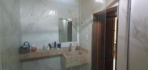 a bathroom with a sink and a mirror at Studio Figueira, Sol in Santarém +17 photos