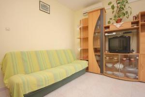 a living room with a couch and a tv at Apartments Zoki in Vis