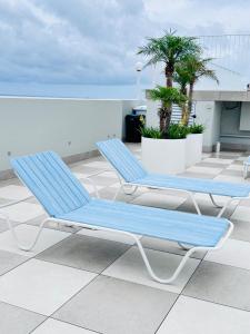 two blue lounge chairs sitting on a roof at HolidayRento Bondi Rooftop Pool & Air Con Studio in Sydney