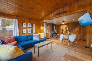 a living room with a blue couch and a table at Camp Hudson Pines in Corinth