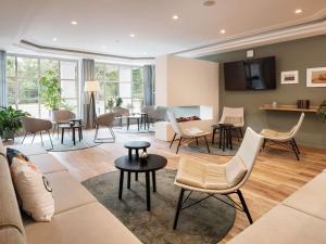 a living room with a couch and chairs at ibis Styles Neckarsulm in Neckarsulm