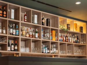 a bar filled with lots of bottles and glasses at ibis Styles Neckarsulm in Neckarsulm