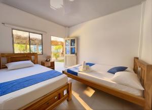 a bedroom with two beds and a window at Tintipan Hotel in Tintipan Island