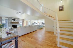 a living room with a staircase and a living room at Groups Welcome, Central Location! Tulsa Gem + Yard in Tulsa