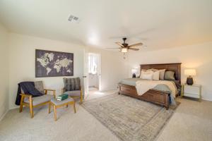 a bedroom with a bed and a fan and chairs at Groups Welcome, Central Location! Tulsa Gem + Yard in Tulsa