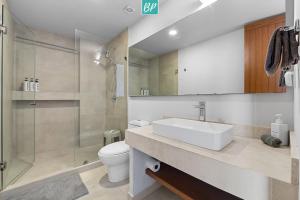 a bathroom with a sink and a toilet and a shower at Makare Bucerias - Rooftop Pool and Steps to Beach in Bucerías