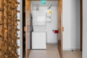 a kitchen with a washer and dryer in a room at Makare Bucerias - Rooftop Pool and Steps to Beach in Bucerías