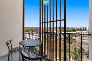 a table and chairs on a balcony with a view of a street at Makare Bucerias - Rooftop Pool and Steps to Beach in Bucerías