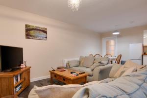a living room with a couch and a tv at 3 Bed in Great Waldingfield oc-ac2 in Waldingfield