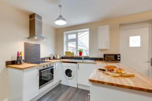 a kitchen with white appliances and a wooden counter top at 3 Bed in Great Waldingfield oc-ac2 in Waldingfield