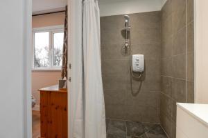 a bathroom with a shower with a shower curtain at 3 Bed in Great Waldingfield oc-ac2 in Waldingfield +8 photos