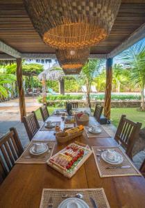 a wooden table with food on top of it at Atins - Vila Mani com piscina in Atins