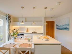 a white kitchen with a table and chairs at 1 Bed in Hythe oc-89966 in Hythe