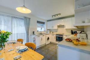 a kitchen with a wooden table and a counter top at 3 Bed in Porthleven oc-1seav in Porthleven
