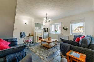 a living room with two couches and a table at 3 Bed in Porthleven oc-1seav in Porthleven