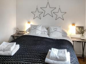 a bedroom with a black and white bed with stars on the wall at At Last in Rhiconich