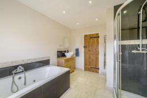 a bathroom with a large tub and a shower at 5 Bed in Langport oc-h33495 in Langport +37 photos