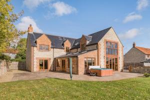 a large brick house with a large patio at 5 Bed in Langport oc-h33495 in Langport