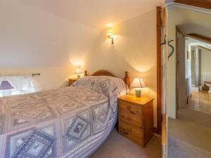 a bedroom with a bed and a wooden dresser at 3 Bed in Syderstone oc-kt083 in Syderstone