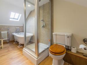 a bathroom with a shower and a toilet and a sink at 3 Bed in Syderstone oc-kt083 in Syderstone +10 photos