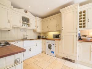 a kitchen with white cabinets and a washer and dryer at 2 Bed in Dersingham oc-kt082 in Dersingham +9 photos