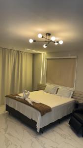 a bedroom with a large bed with a ceiling at Pousada nascer do sol in Portalegre