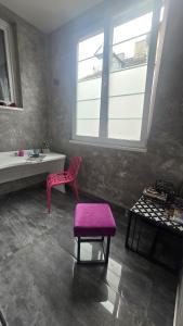 a room with a pink stool and a table and a window at Up Hostel in Belgrade +58 photos