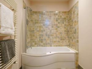 a white bath tub in a bathroom with tiles at 3 Bed in Richmond oc-86747 in Gilling +21 photos