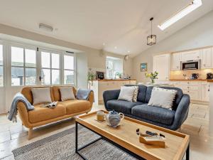 a living room with two couches and a coffee table at 2 Bed in Ventnor oc-88857 in Niton