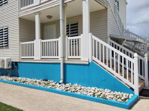 a house with a bunch of rocks on the porch at Ola Azul Apartment in Punta Santiago