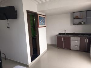 a kitchen with a sink and a door in a room at La Mesa Suites - Hermosa vista in La Mesa