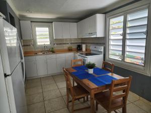 a kitchen with a table with a blue table cloth on it at Ola Azul Apartment in Punta Santiago