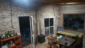 a living room with a table and a brick wall at Finca Santiago in San Miguel del Monte