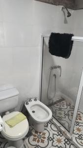 a bathroom with a white toilet and a shower at Finca Santiago in San Miguel del Monte