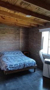 a bedroom with a bed in a brick wall at Finca Santiago in San Miguel del Monte