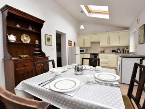 a kitchen with a table with plates on it at 2 Bed in Holmesfield oc-pk783 in Dronfield +6 photos