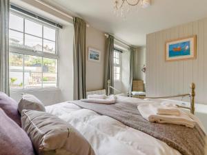 a bedroom with a large bed with towels on it at 2 Bed in Fowey oc-91396 in Fowey