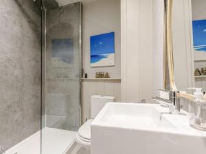 a bathroom with a shower and a sink and a toilet at 2 Bed in Fowey oc-91396 in Fowey