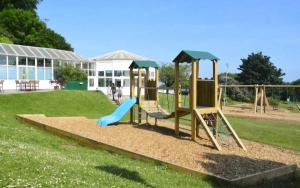 a playground with a slide in a park at 43 sea valley in Bideford +3 photos