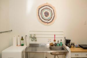 a kitchen with a sink and a refrigerator at Object Hotel 2BR Room 2G in Bisbee +18 photos